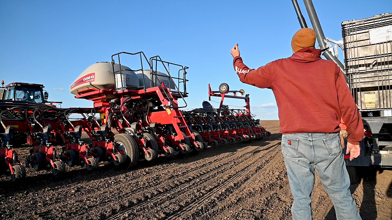Farmers Loading Planter with Seed Tender