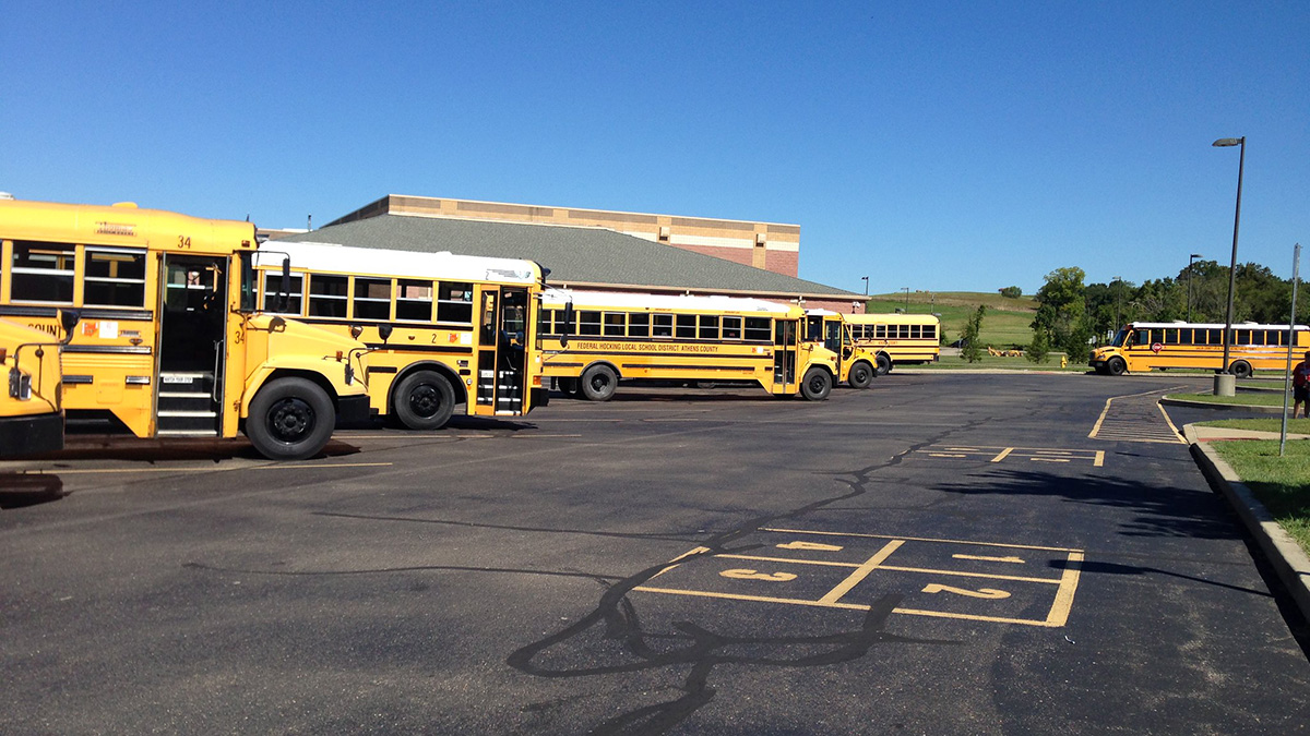 School buses in parking lot.