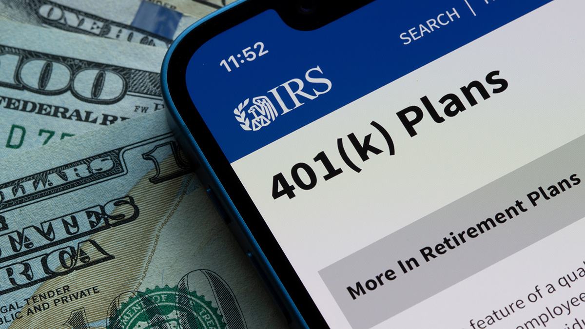 Photo illustration of a cell phone with IRS 401(k) web page open.