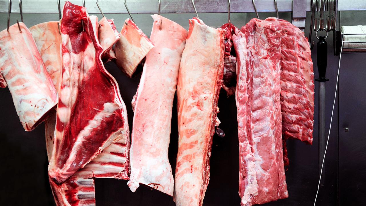 Meat hangs in locker.