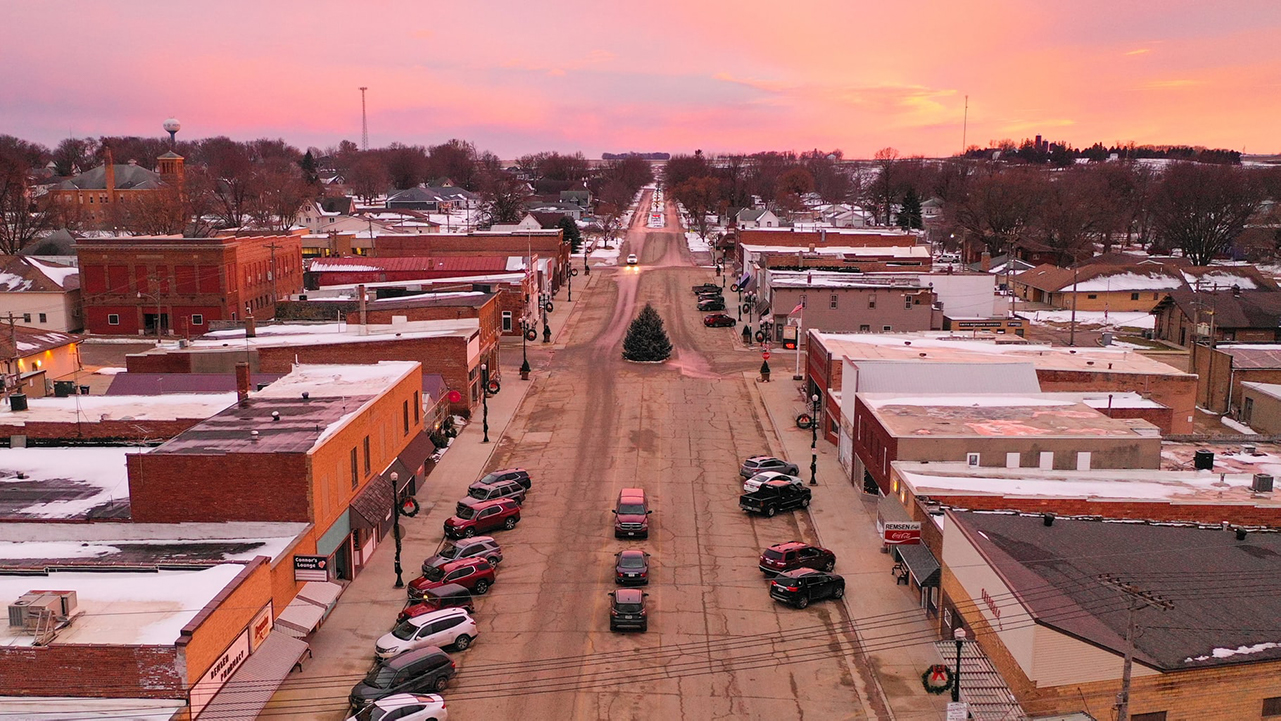 Drone shot looking down main street of small town.