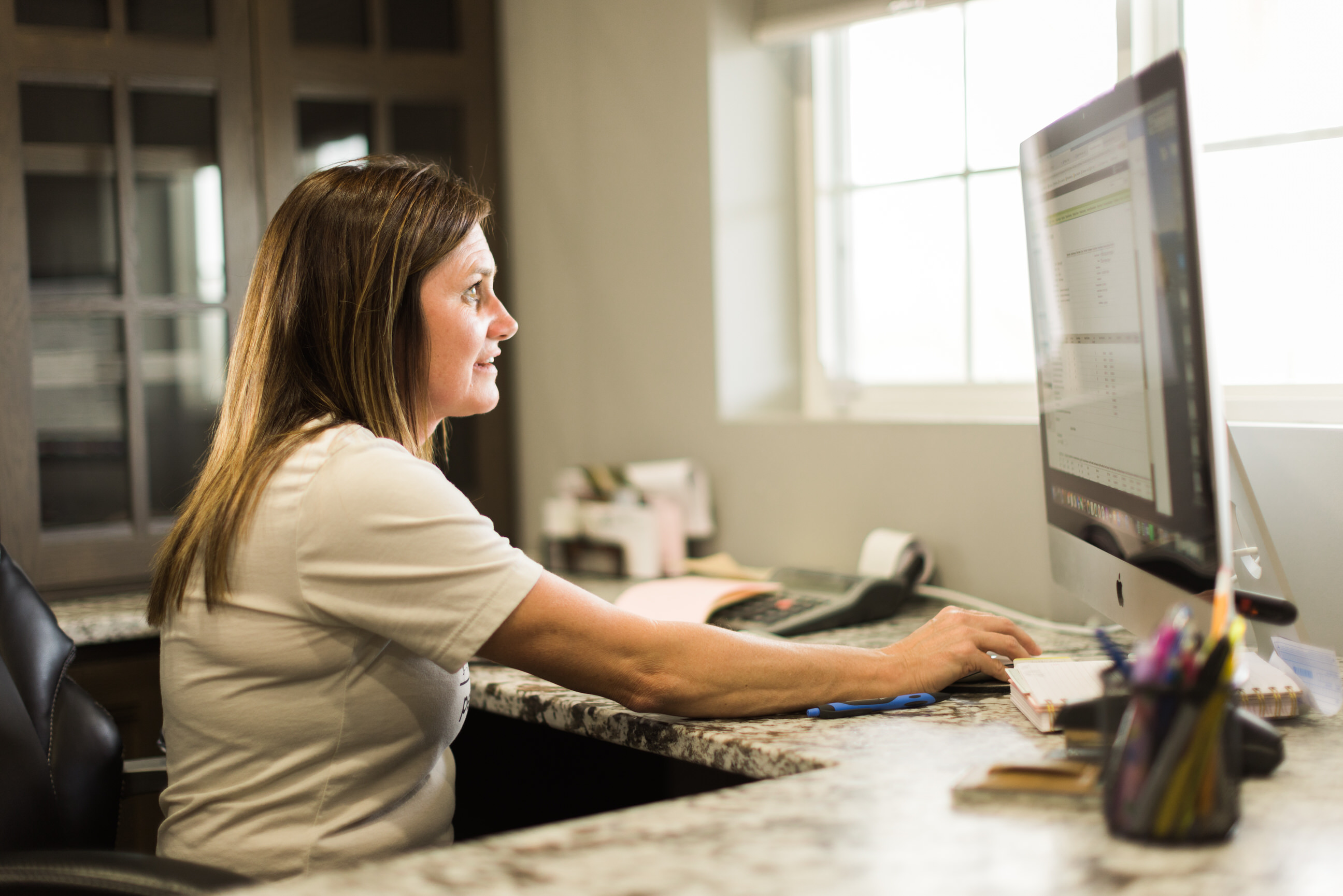 Woman Farmer Works on Computer in Office
