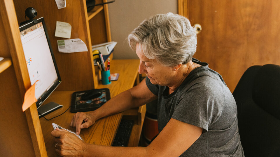Female farmer working at computer.