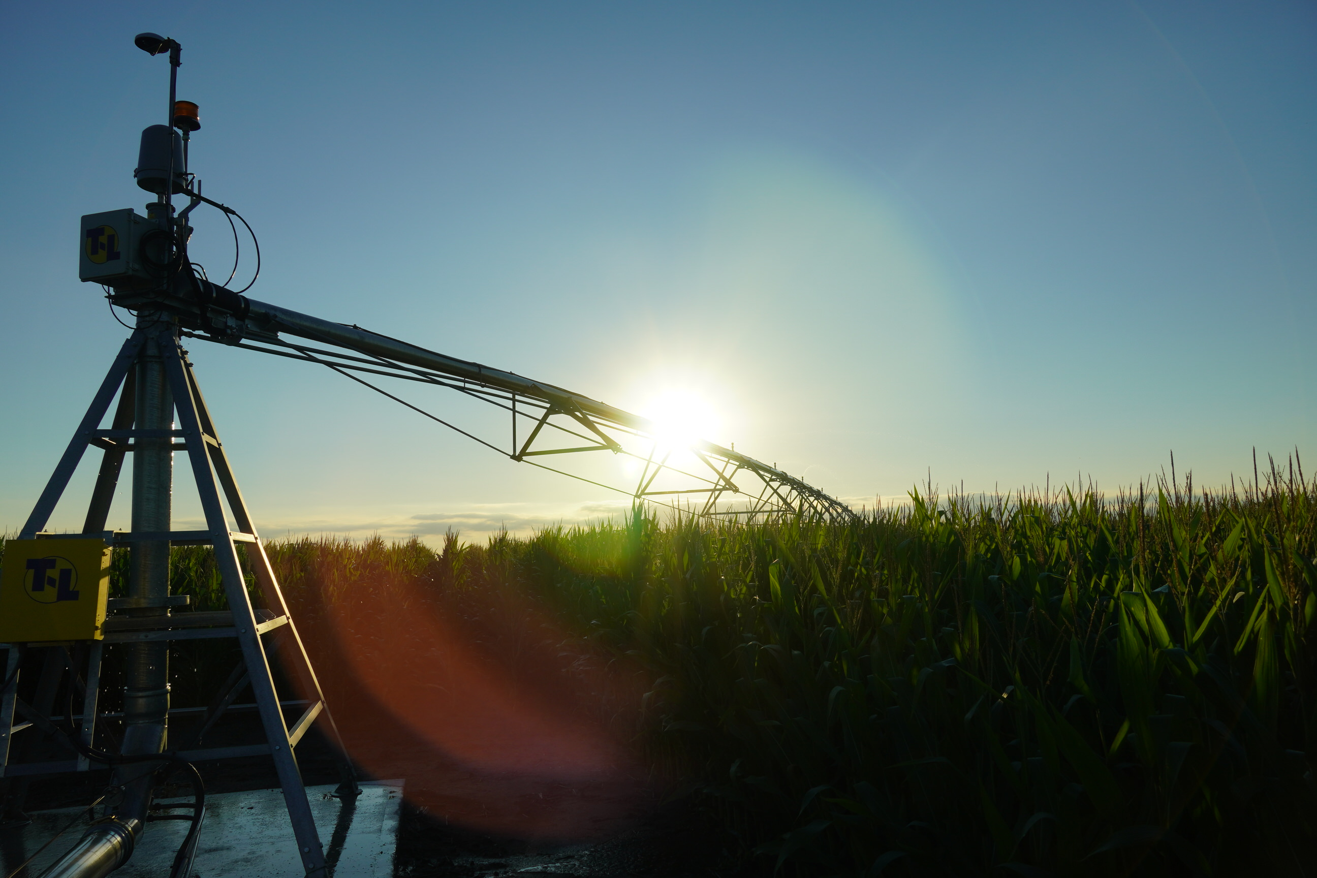 Sunrise over an irrigation pivot.