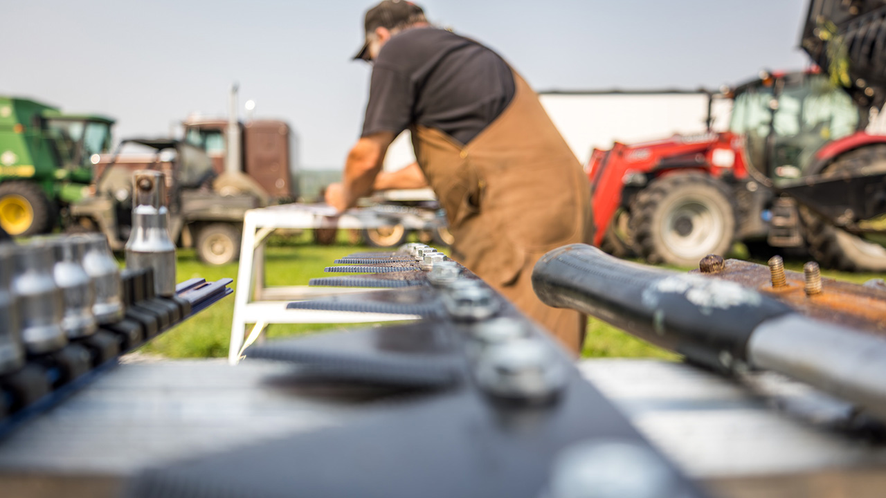 Farmer fixing swather.