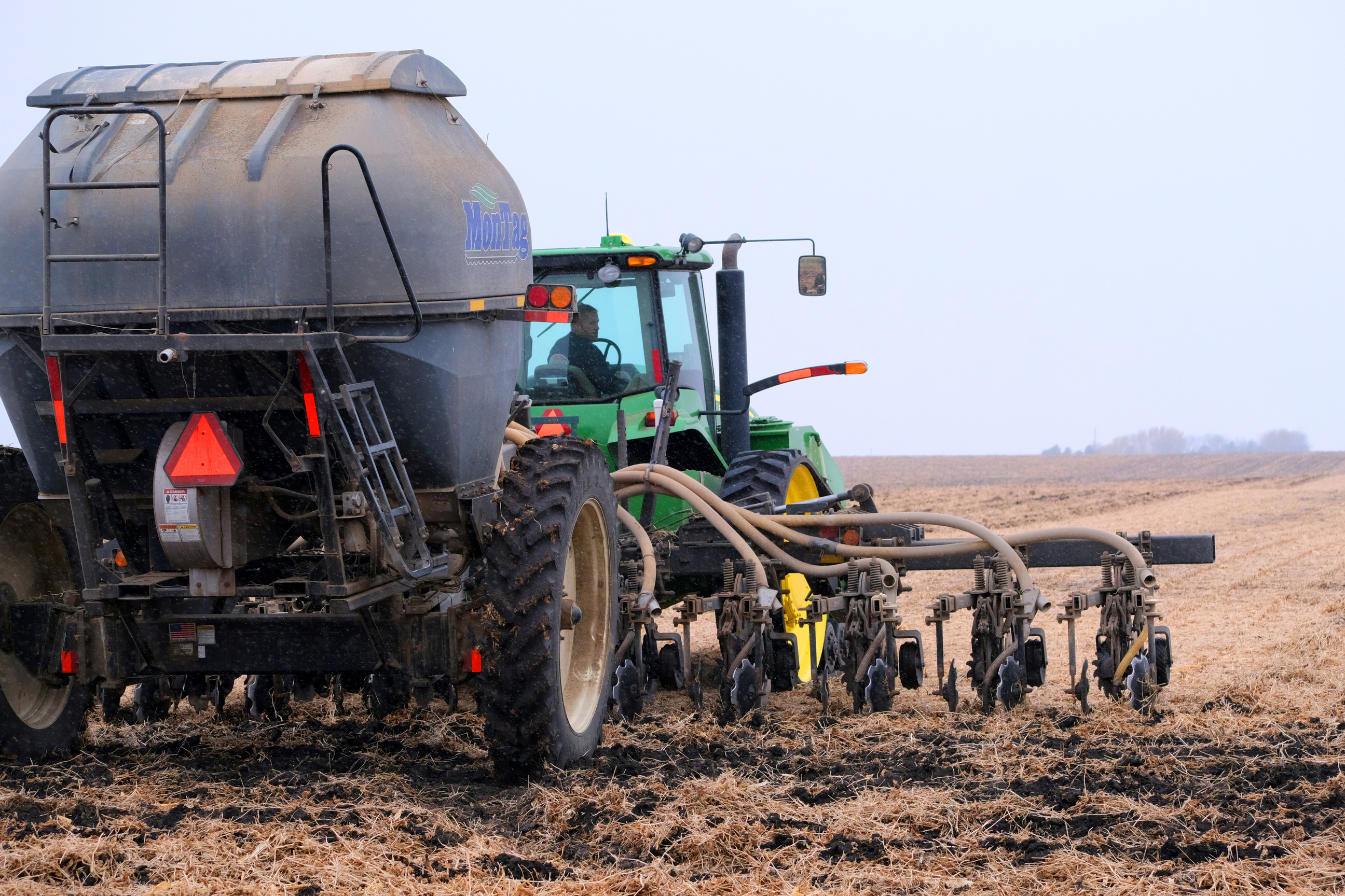 Injecting manure in field.