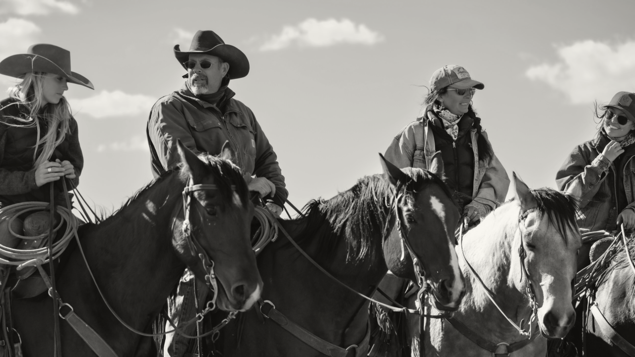 Photo of a ranch family on horseback.