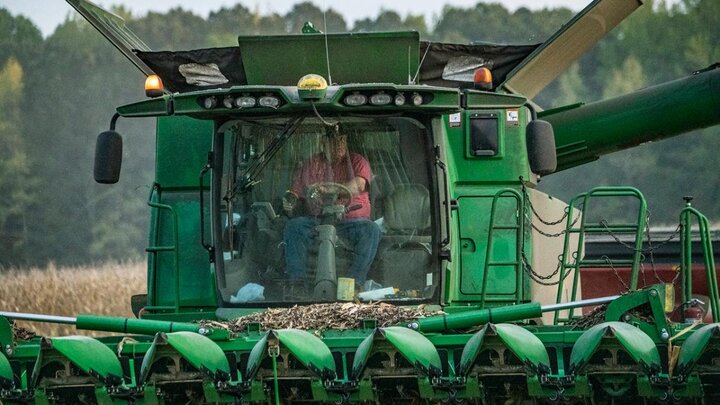 Farmer driving combine.