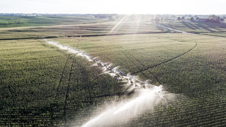 Aerial view of center pivots in fields.