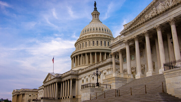 Photo of the U.S. Capitol from the bottom of the Senate steps with the dome in view.