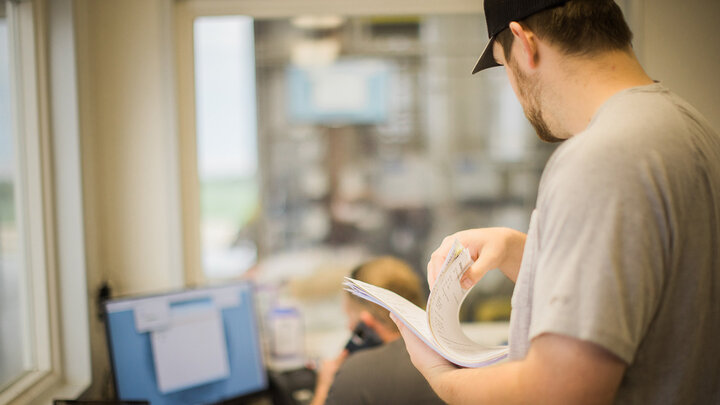 Photo of two men working in a farm office.