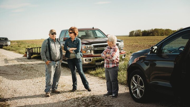 Family standing outside of vehicles.