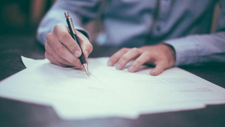 Pen writing on paper.