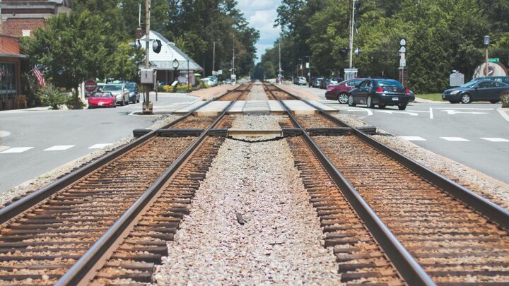 Photo of train tracks going through rural town.
