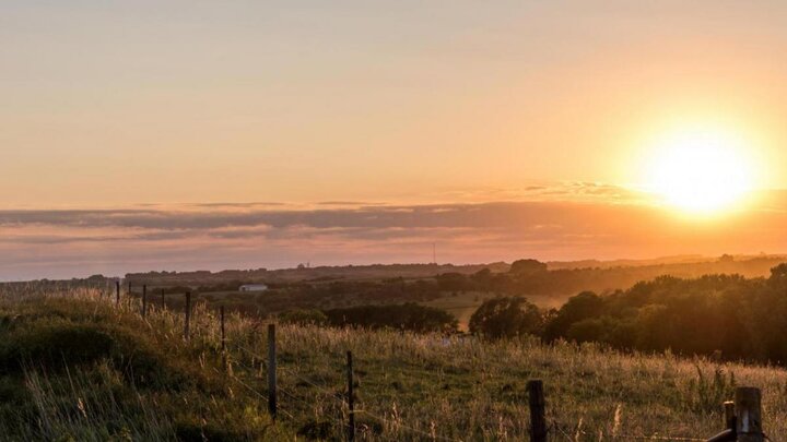 Sunset over land.