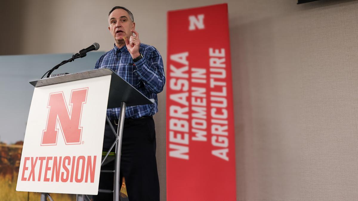 Jay Parsons speaking at the podium during the 2024 Nebraska Women in Agriculture Conference.