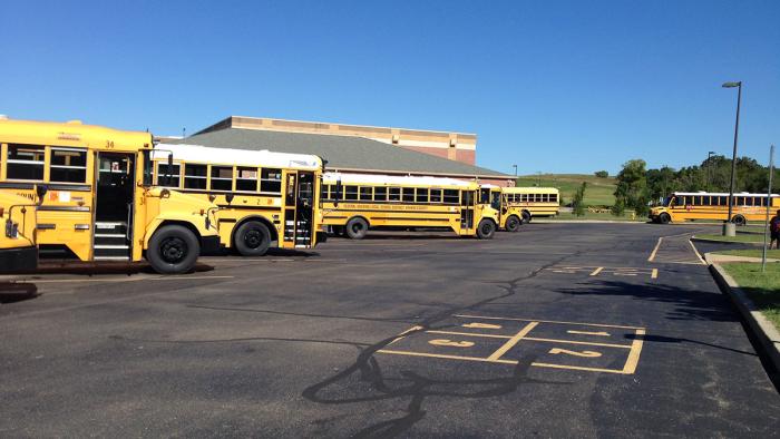 School buses in parking lot.