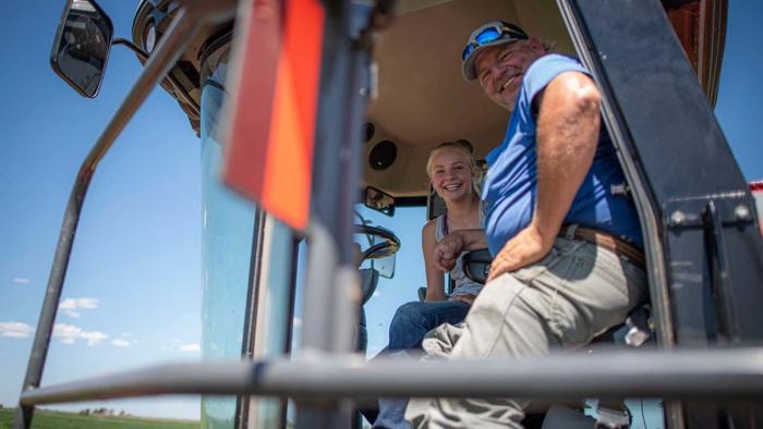 Father and daughter in combine.