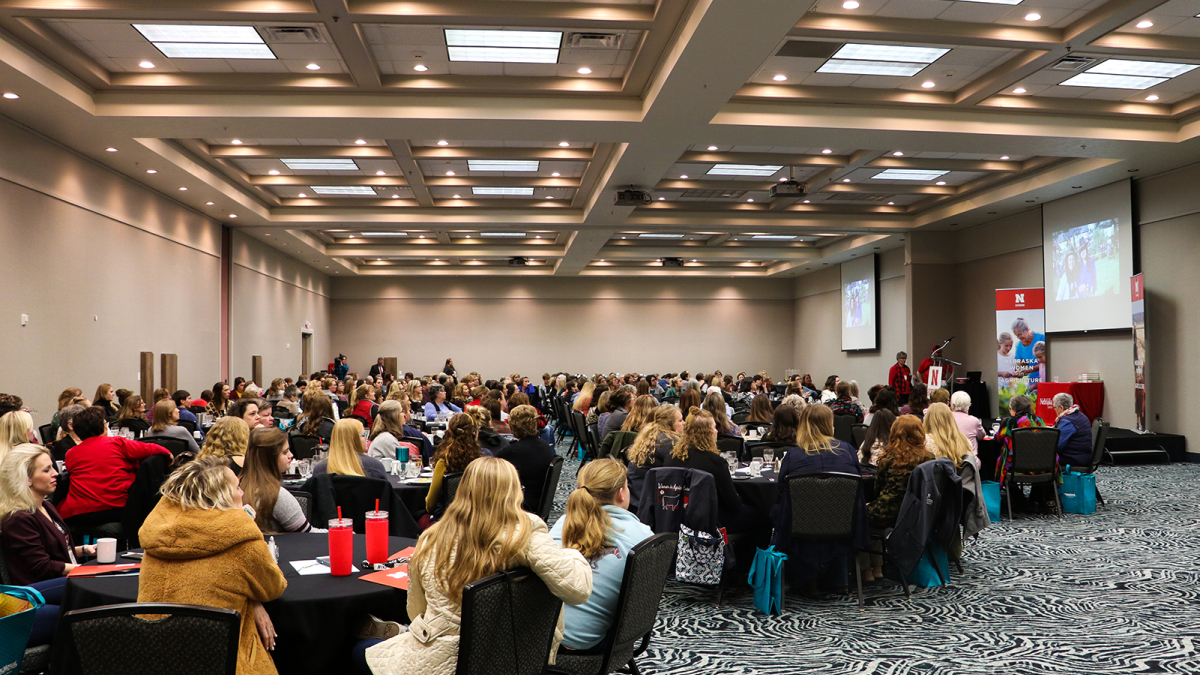 2023 Nebraska Women in Agriculture conference keynote session in ballroom with attendees seated at tables facing stage.